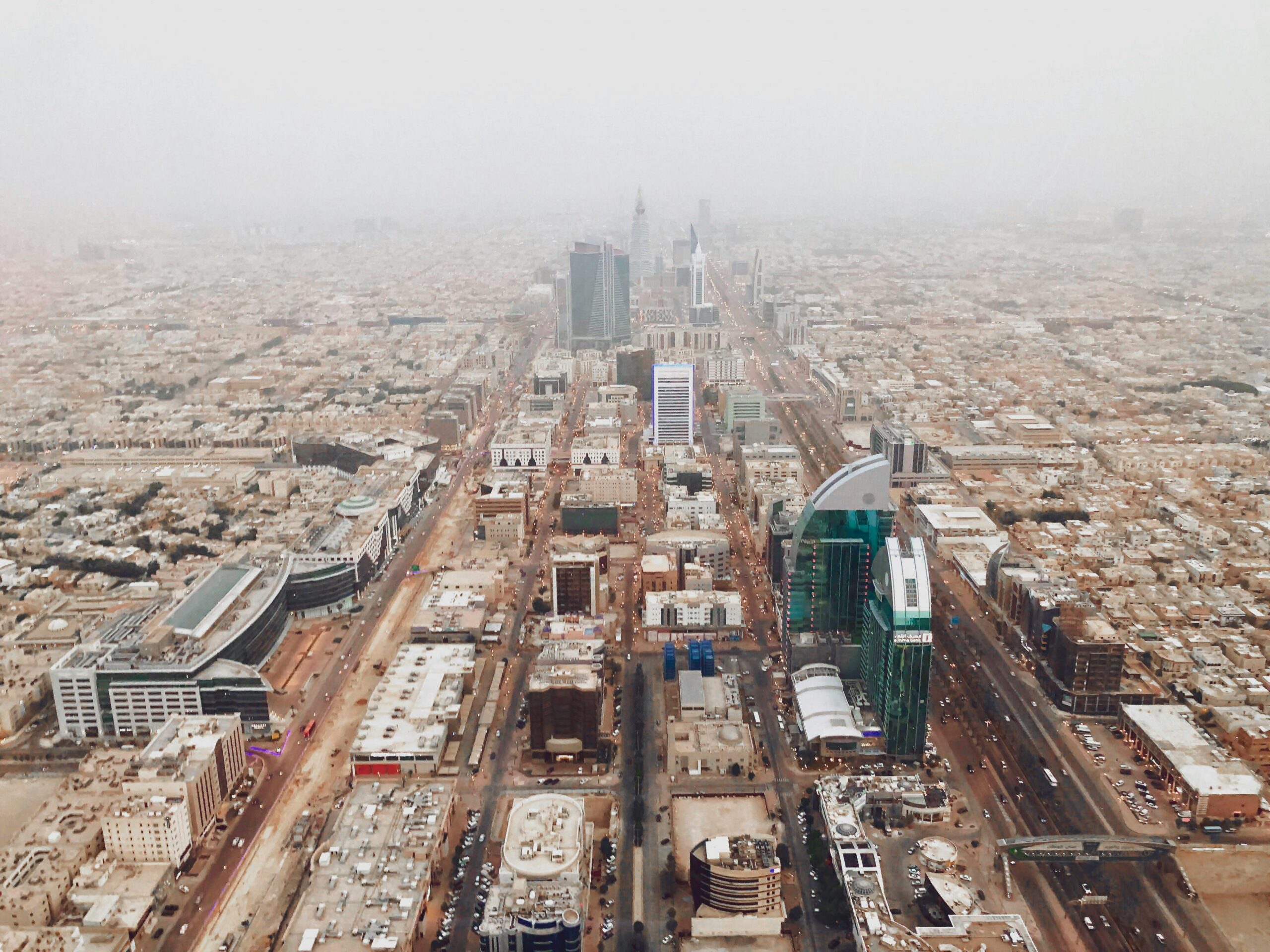 Aerial photograph of Riyadh's modern cityscape with iconic skyscrapers and bustling streets.