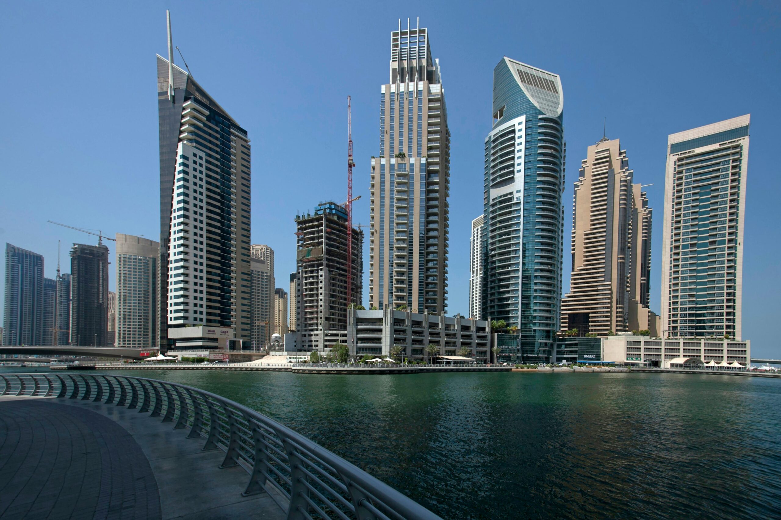 Explore the stunning skyline of Dubai Marina with modern skyscrapers reflecting on the waterfront.